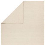 Top corner fold revealing both front and back solid beige rug surfaces with tight weave