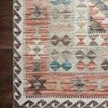 Detailed corner close-up highlighting geometric border pattern and soft earth tones on dark wood floor.