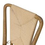 Close-up view of the cream cushion fabric on the seat of the chair