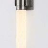 Close-up of illuminated seedy opal glass cylinder and metalwork in vintage pewter finish