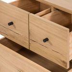 Top view of nightstand drawers opened, showing smooth wood interior and black metal knobs
