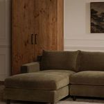 Hutton sectional set in a room with wooden cabinet and beige walls
