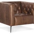 Close-up angled front view emphasizing tufted seat and arms in rich saddlebag leather