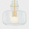 Close-up of Lumi Pendant highlighting glowing frosted bulb and brass frame details inside clear glass
