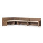 Simple rattan bench set arranged in corner of dining room with neutral cushions and decor