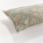 Corner view focusing on the striped edging and textured floral fabric of the pillow front