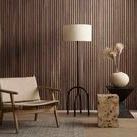 Faydon End Table styled in living room with wood paneled wall, mid-century chair, and modern floor lamp