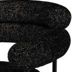 Close-up of textured black and salt-and-pepper upholstery on rounded backrest and armrest