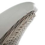 Close-up of woven wicker detail beneath softly rounded white vinyl cushion edge