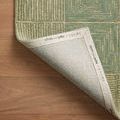 Francis Green rug corner lifted to show branded fabric backing