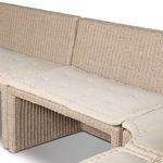 Detail of button tufting on light beige seat cushion fabric