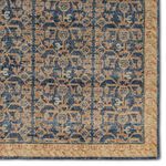 Detailed corner section of the rug highlighting the orange and cream border pattern
