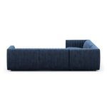 Side view opposite angle showing thick navy velvet arm and tufted back texture