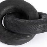 Close angle showing overlapping loops of the wood knot sculpture emphasizing its rounded edges and wood texture