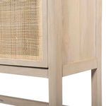 Close-up of cabinet base corner showing clean lines and joinery on natural wood