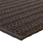 Close-up of thick woven brown and gray fibers with braided texture and fabric edge binding