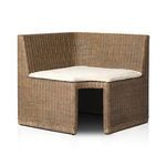 Opposite angle showcasing rattan weaving and beige cushion side profile