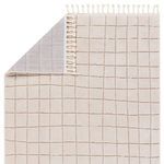 Top view showing back side folded over revealing gray woven non-slip backing and fringe