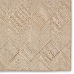 Close-up detail of chevron pattern with tan and ivory striped pile in rug corner