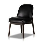 Black leather armless dining chair with curved backrest and dark wood legs
