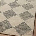 Detailed macro view of Francis Rug showing wool yarn loop texture in beige and charcoal diamond pattern