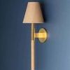 Side view of Lindenwood Wall Sconce showing brass arm extending from circular wall mount