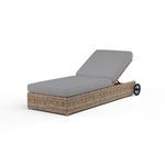Outdoor adjustable chaise lounge in weathered tobacco wicker with gray cushioned seat and backrest, with backrest reclined