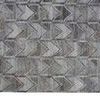 Close-up of Beckett rug showing detailed chevron shapes and varied gray tones with fringed edge