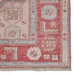 Flat, zero-pile Anatolian-inspired rug with pink and sky blue geometric medallion and ornate border design