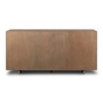 Back of dresser with plain, light oak surface and small support feet visible