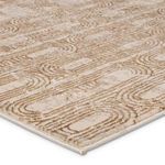 Close-up on textured gold and beige geometric pattern with shimmering, raised pile details