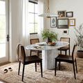 Sorrento Mocha rug in dining room with oval marble table and dark wood chairs