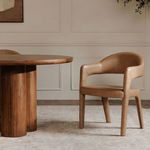 Martens dining chair placed beside a round wooden table in a styled dining room setting
