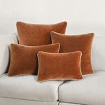 Group of Harriet Velvet Throw Pillows in different shapes arranged on white sofa