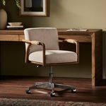 Rosie desk chair styled in a room with wood desk, olive wall, and hardwood floor