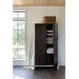 Shasta Wardrobe door partially open revealing stored pillows, blankets, and woven basket on top