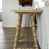Side angle of Kirkwood Console Table showing decorative book holder and stacked books on the wood top