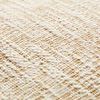 Close-up of the textured cotton fabric showing woven ivory and beige threads of the pillow