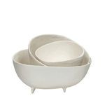 Set of three off-white aluminium bowls in varying sizes with textured, irregular edges and small feet