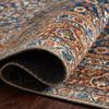 Edge of Layla rug folded over to reveal backing, showing flexibility and weave detail