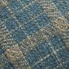 Close-up of Earl pillow showing detailed textured weave and check pattern in teal and tan