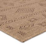 Close-up highlighting flatwoven material and detailed pattern of brown geometric lines and shapes