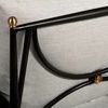 Detailed close-up of sofa frame's brass accent and cushion fabric weave