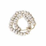 Close-up of large rounded white cow bone beads loosely coiled with visible natural cracks and imperfections