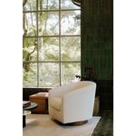 Oscy swivel chair in cozy room setting by large window with green tiled walls