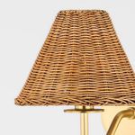 Close-up showing woven rattan shade texture and brass holder detailing