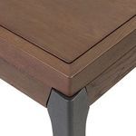 Close-up on joint of oak frame and iron leg with phongraphic shadowing