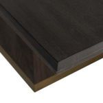 Close-up showing beveled edge and corner detail of the table top with gold-toned banding below