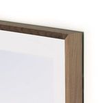 Close-up of walnut frame edge highlighting smooth wood texture and light wood tones