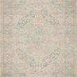 full view of the rectangular rug displaying full faded floral medallion design in muted tones